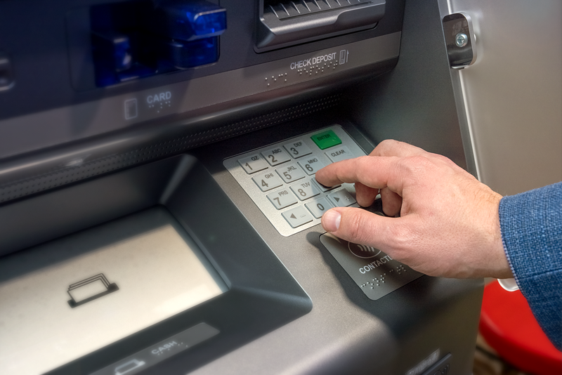 Man using a self-service , core-integrated ITM